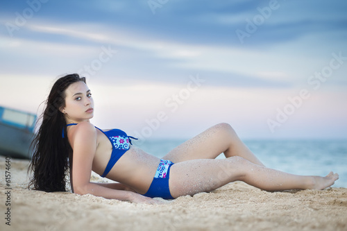Young brunette posing near the sea