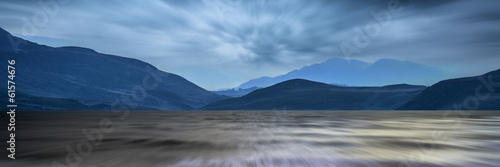 Long exposure panorama landscape of stormy sky and mountains ov