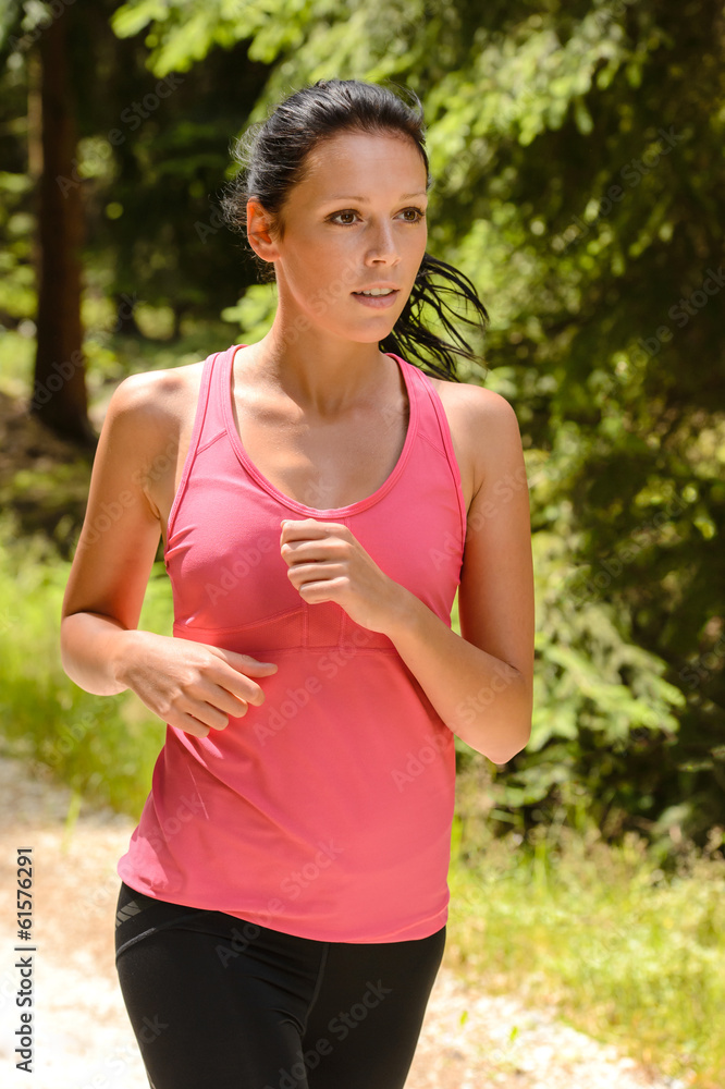 Jogging woman close-up running in countryside Jogging woman close-up running in countryside