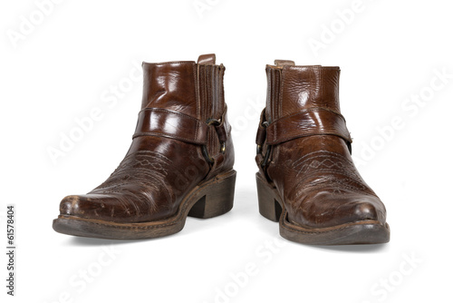 Old and worn cowboy boots isolated with clipping path.