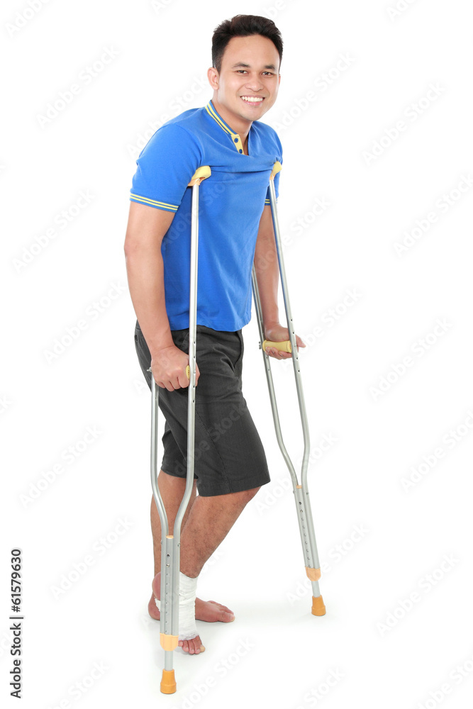male with broken foot using crutch