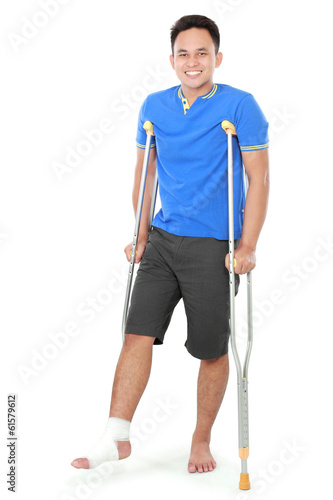 male with broken foot using crutch Fototapeta
