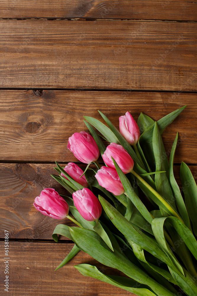 Beautiful pink tulips on wooden background Beautiful pink tulips on wooden background