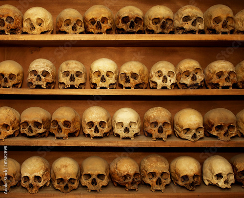 skulls on a shelf in the tomb