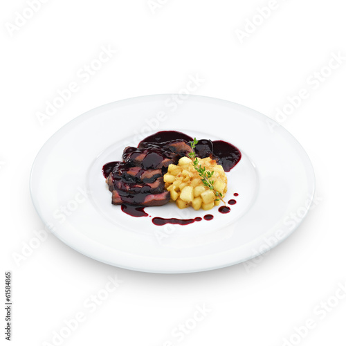 Delicious roasted sliced duck breast meat under wine and berry s