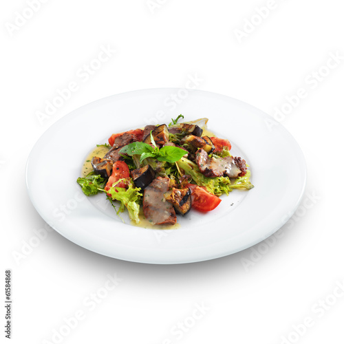 Delicious healthy warm salad with beef and vegetables on a round