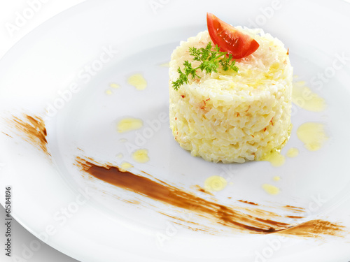 Health vegetarian rice with tomato and butter on a round plate i