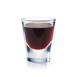 Red berries liqueur is the shot glass isolated on white. Bar and