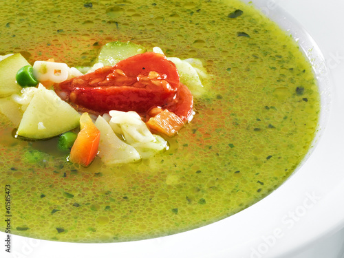 Hot vegetarian healthy soup with pesto sauce, noodles and vegeta