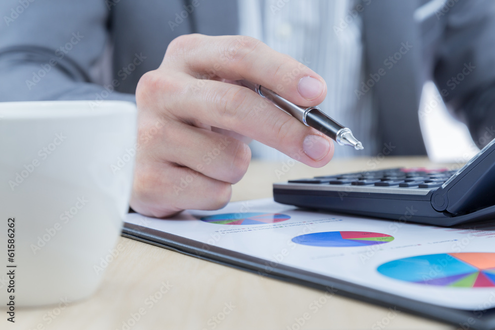 Businessman's hand showing financial report Businessman's hand showing financial report