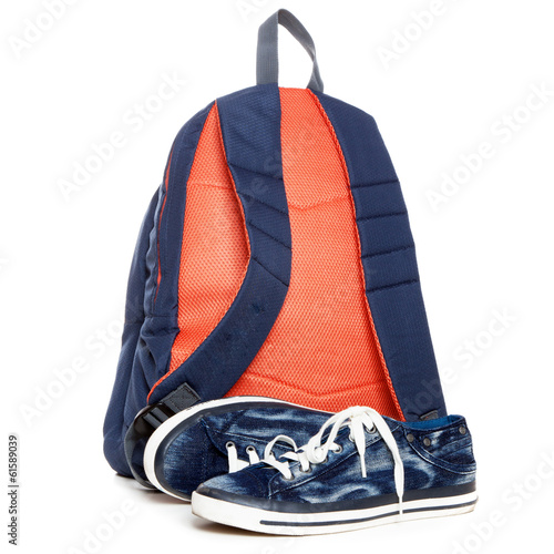 Backpack and sneakers on white background photo