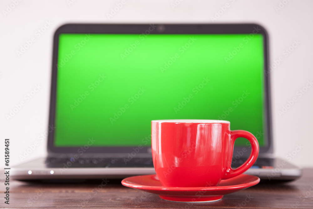 Laptop and a coffee cup