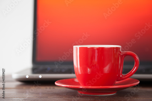 Laptop and a coffee cup
