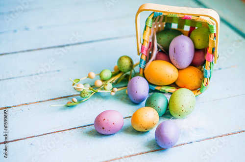 Easter eggs in the basket on blue wooden background