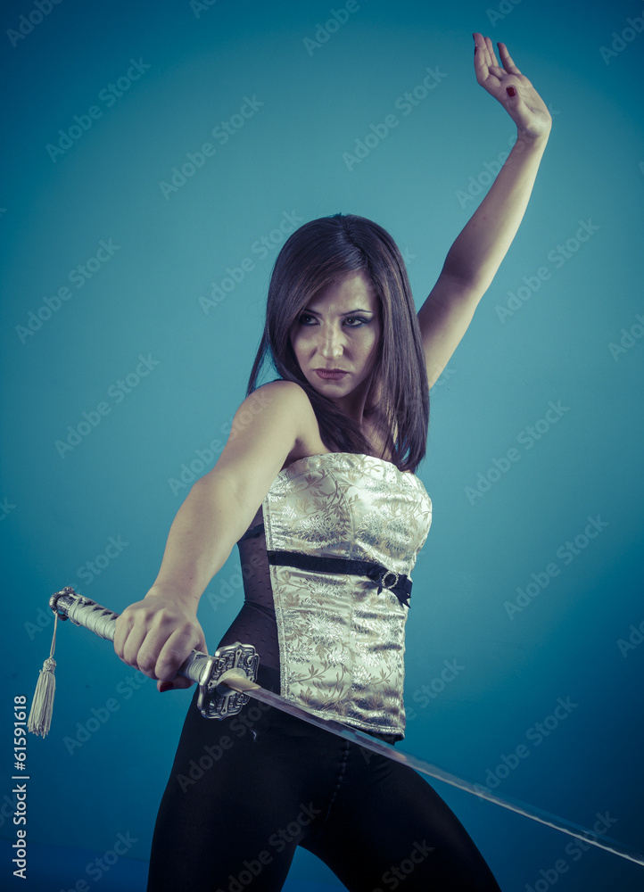 Beautiful brunette girl with Katana in studio Beautiful brunette girl with Katana in studio