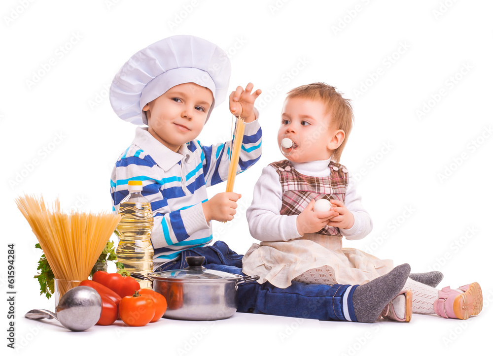 funny kids are cooking on the kitchen. isolated funny kids are cooking on the kitchen. isolated
