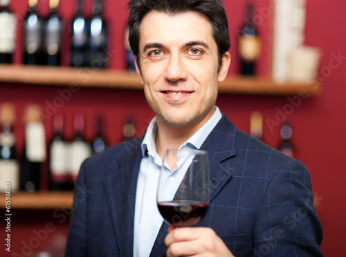 Handsome man holding a glass of wine