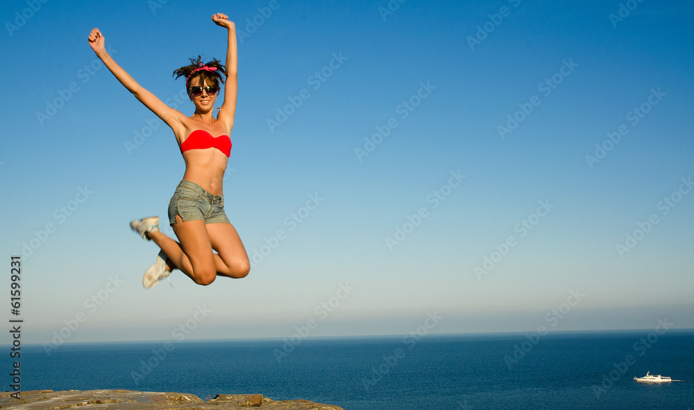 slim girl  jumping on the background of sky