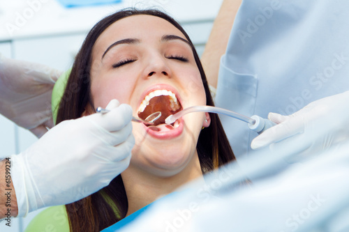 Cute young woman at the dentist. Mouth checkup
