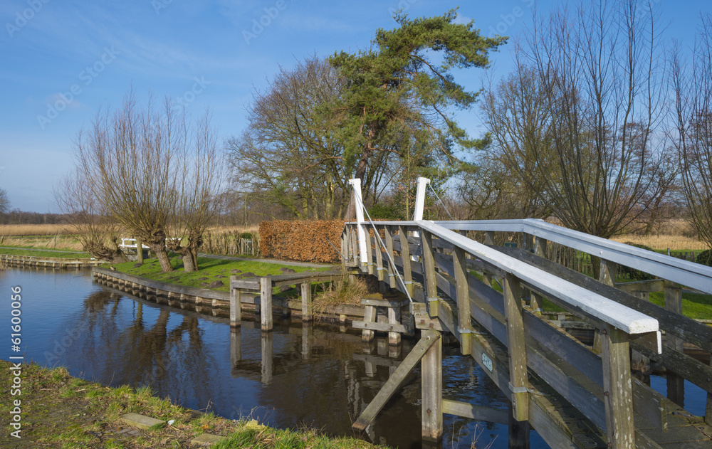 Wooden bridge over a canal in winter