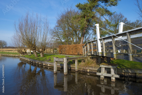 Wooden bridge over a canal in winter