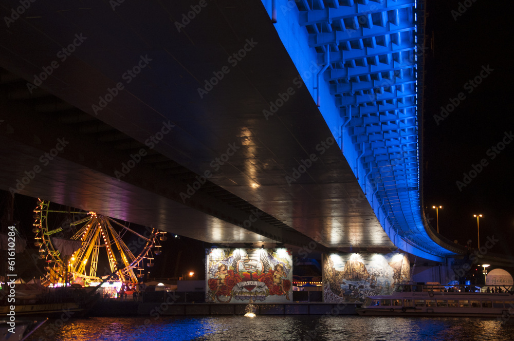 bridge illuminated at night by the river