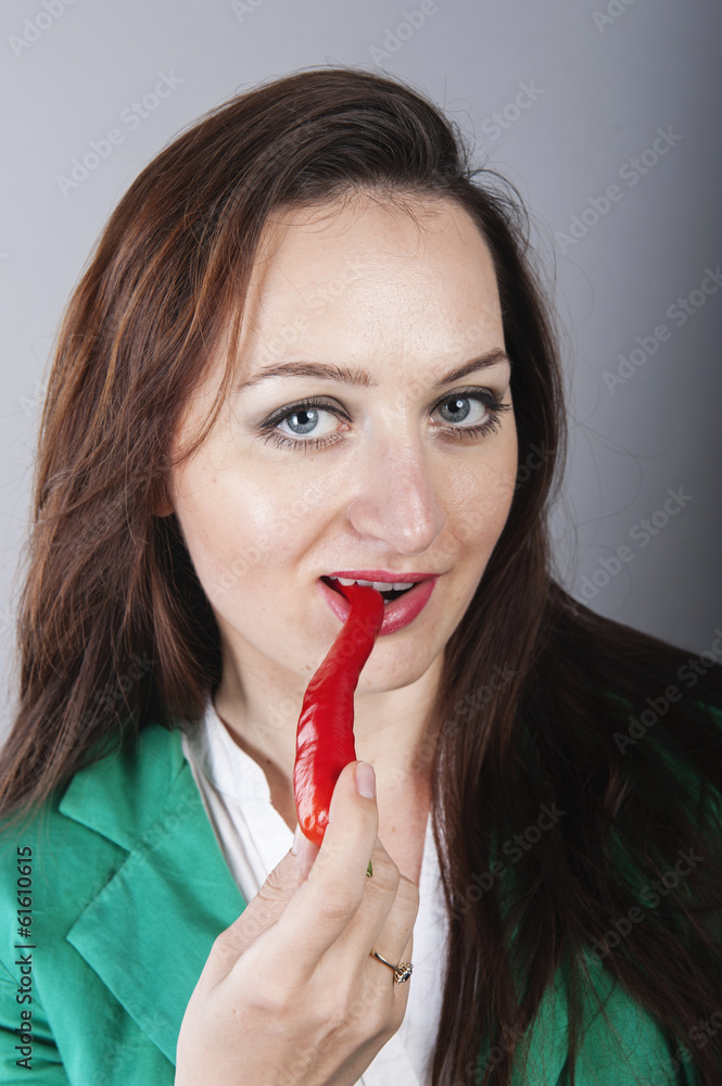 businesswoman holding red chilli pepper businesswoman holding red chilli pepper