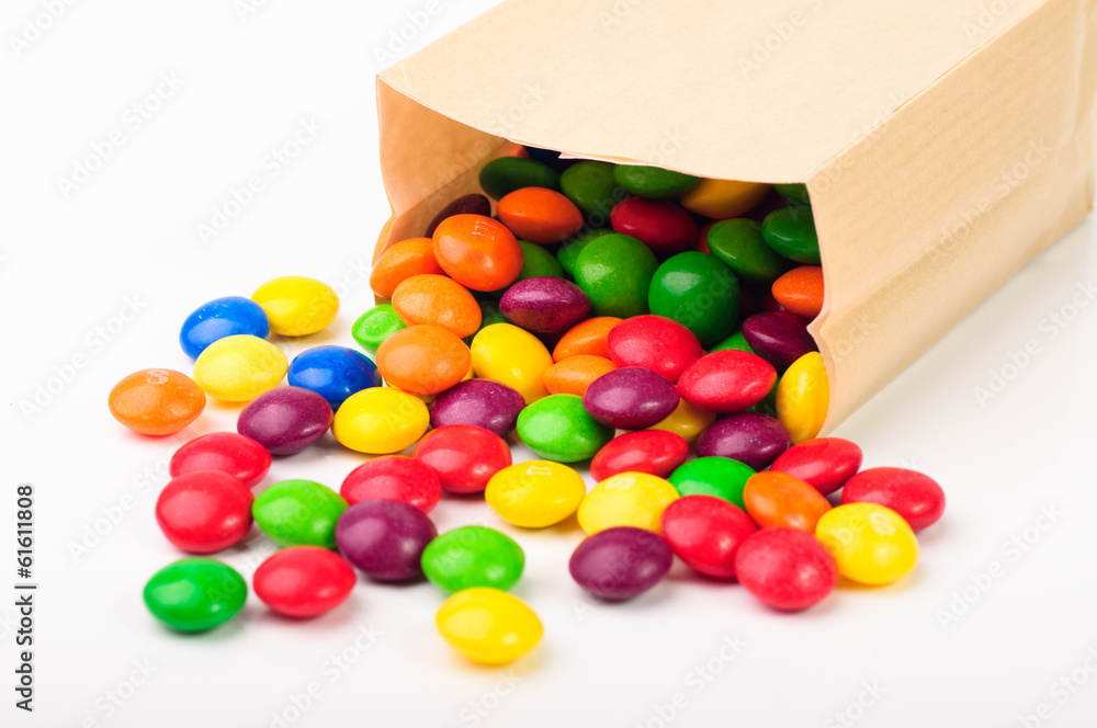 Obraz na plátně Colorful chocolate candies in a paper bag