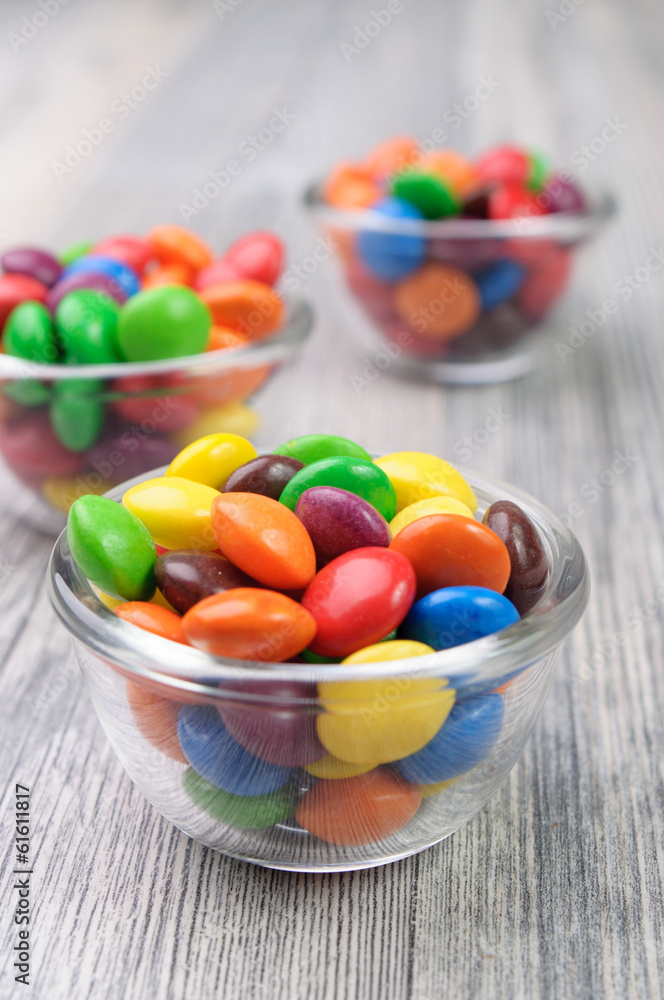 Three tiny bowls with colorful chocolate candies Three tiny bowls with colorful chocolate candies
