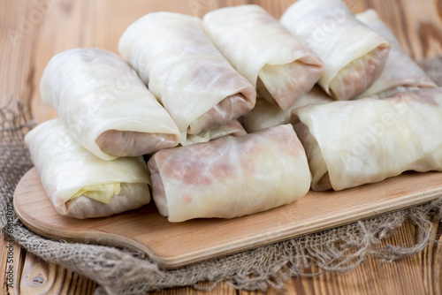 Uncooked cabbage rolls stuffed with minced meat and rice