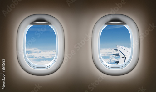Two airplane windows. Jet interior.