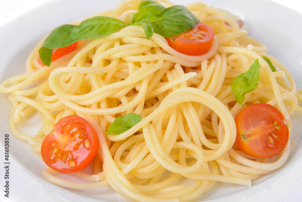 Delicious spaghetti with tomatoes on plate close-up Delicious spaghetti with tomatoes on plate close-up