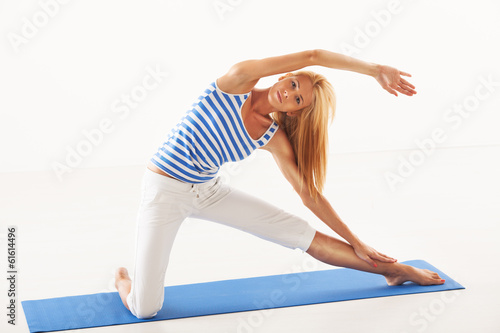 Beautiful woman doing Yoga gate pose.