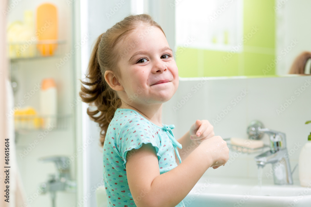 kid girl washing his face and hands in bathroom kid girl washing his face and hands in bathroom