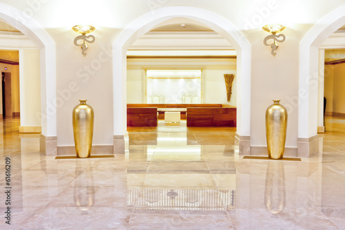 Hall or foyer with a marble floor and arches
