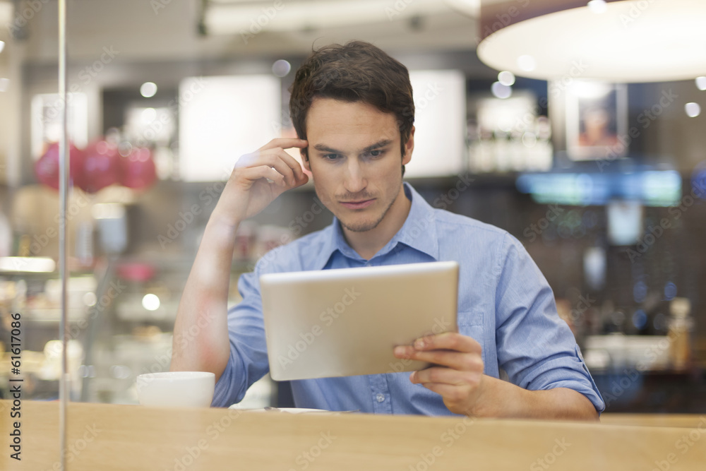 Focus man in cafe with digital tablet Focus man in cafe with digital tablet