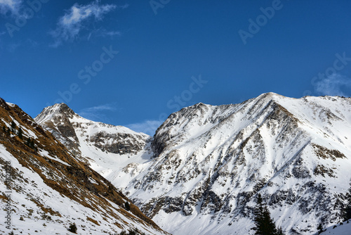 Snow covered mountains and rocky peaks in the Romanian carpatian
