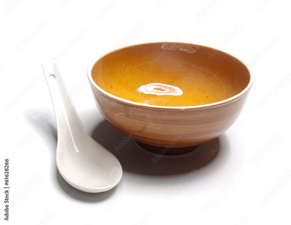 Orange plate and china spoon on white background Orange plate and china spoon on white background