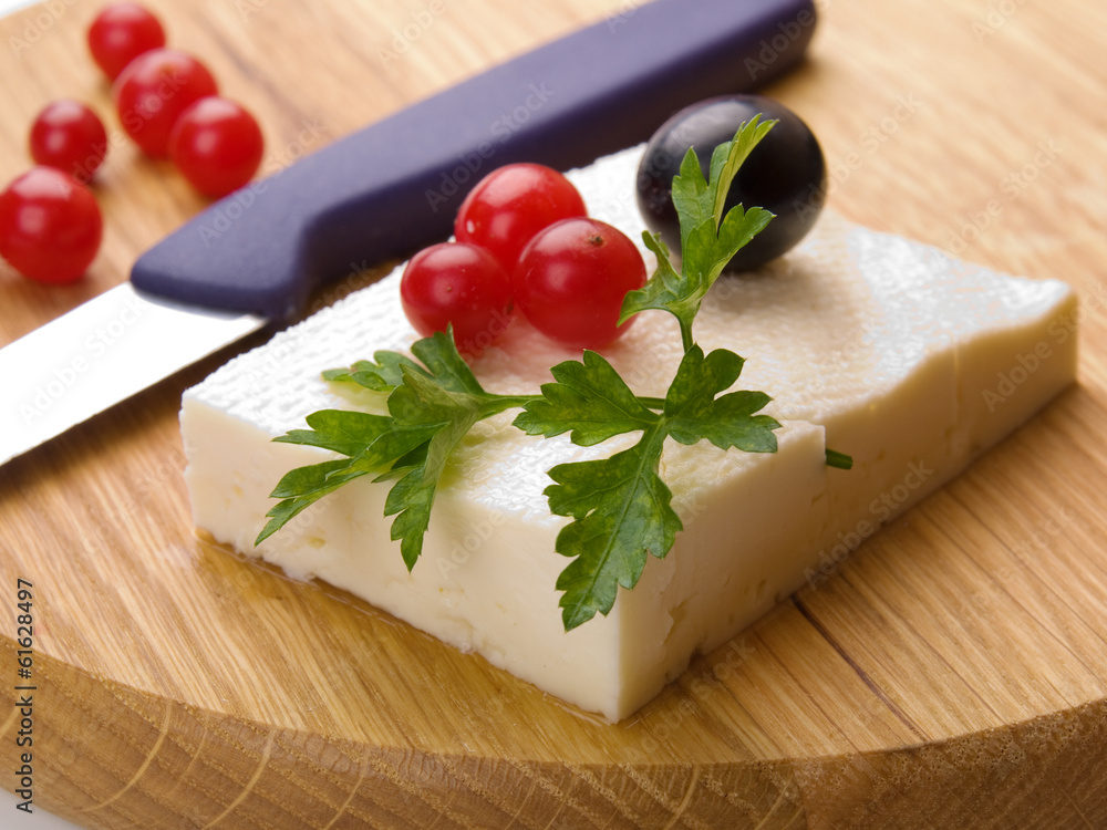 feta cheese and cranberries on wooden cutting board feta cheese and cranberries on wooden cutting board
