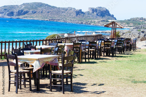 Table and chairs of a Greek taverna on the sea coast