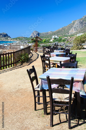 Table and chairs of a Greek taverna on the sea coast