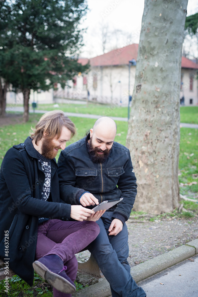 two bearded modern man working on tablet two bearded modern man working on tablet