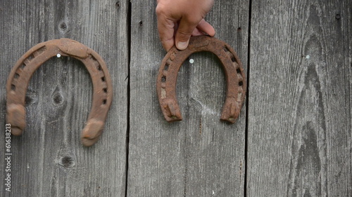 hand hanging on wall nail horseshoe and swings