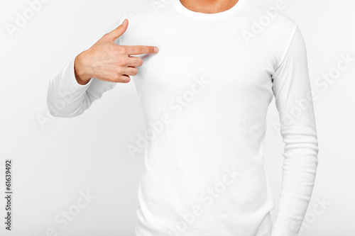 Close-up of a man pointing his fingers on a blank t-shirt