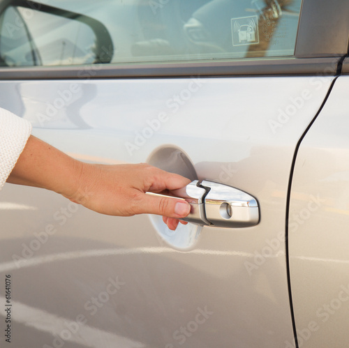 woman opens car door close up