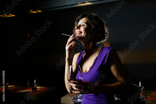 Attractive lady with cigarette in nightclub