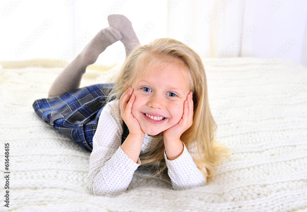 Adorable blonde blue eyed little girl lying happy on bed Stock Photo ...