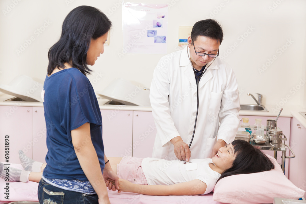 pediatrician using stethoscope to exam little girl pediatrician using stethoscope to exam little girl