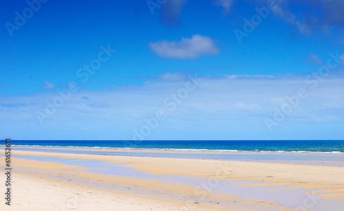 Beautiful wide open beach with blue skies in Summer.