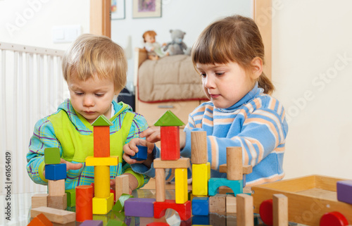 tranquil children playing with wooden toys